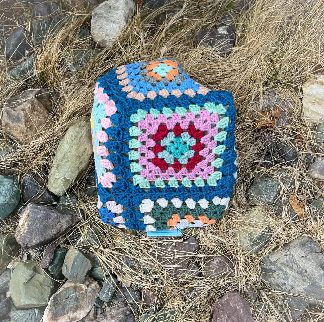 Granny square quilting as a form of rock art  - Newfoundland and Labrador culture is evident from the moment you arrive to the beach hut. A hand knit granny square quilt covered a rock at the entrance.